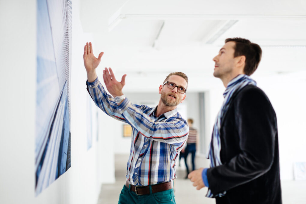An artist Showing Gallery Owner His Work